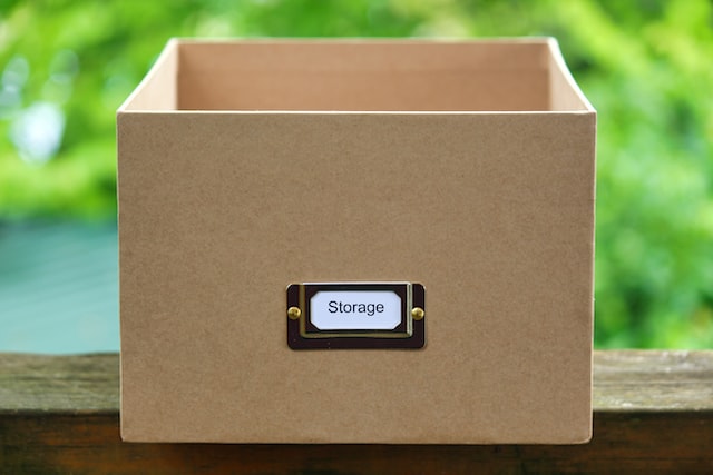 cardboard box with a "storage" tag on it
